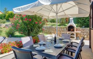 a table with an umbrella on a patio at Stunning Home In Labin in Labin