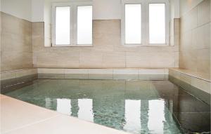 a pool of water in a room with two windows at Gorgeous Home In Skjern in Lem +38 photos