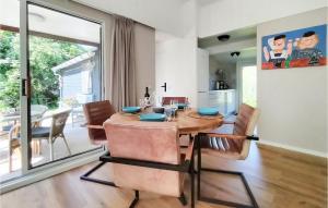 a dining room with a wooden table and chairs at Zeeuwse Parel in Scherpenisse