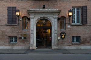 una entrada a un edificio de ladrillo con un arco en Duchessa Isabella Collection by Uappala Hotels, en Ferrara