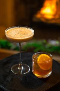 a drink in a glass with an orange slice at Charingworth Manor in Chipping Campden
