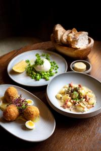 three plates of food on a wooden table at Charingworth Manor in Chipping Campden