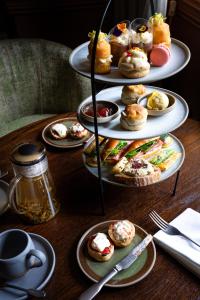 a table with three tiered plates of pastries at Charingworth Manor in Chipping Campden