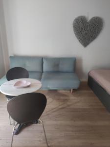 a living room with a couch and a table at Lovely Apartment with pool and garden in Marlengo
