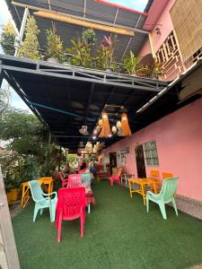 a group of colorful chairs and tables on a patio at Heaven Guesthouse in Pakse