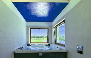 a bathroom with a large bath tub with a blue ceiling at Villa Gloria Vita in Brtonigla
