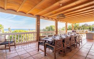 a dining room with a table and chairs on a balcony at Amazing Home In Las Lagunas De Mijas in Fuengirola +30 photos