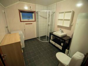 a bathroom with a shower and a toilet and a sink at Hansali Holiday Home in Fjarland +24 photos