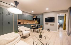 a living room and kitchen with a table and chairs at Beautiful Home In Privlaka in Privlaka