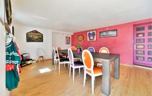 a dining room with a table and chairs at Beautiful Home In Valréas in Valréas