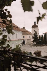 a large white building with a clock tower at n o c t u r n e in Kamianets-Podilskyi +24 photos
