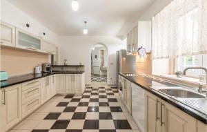 a kitchen with a black and white checkered floor at Five-Bedroom Holiday Home In Vinjani Donji in Bilopavlovići