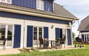 a patio with blue shutters on a house at Ferienhaus 34 Altefähr in Altefähr +22 photos