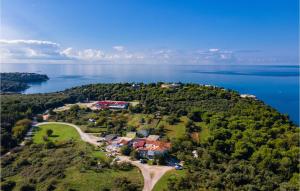 an aerial view of a house on an island in the water at Amazing Apartment In Pula With Wifi in Pula +21 photos