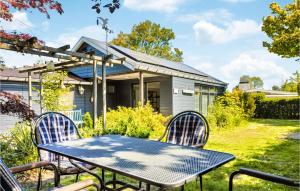 a table and chairs in front of a house at Zeeuwse Parel in Scherpenisse