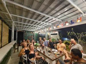a group of people sitting around a table at Surf Camp 79 in Kuta Lombok