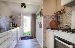 a kitchen with a sink and a stove top oven at Zeeuwse Parel in Scherpenisse
