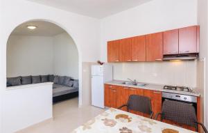 a kitchen with a table and a kitchen with a couch at Two-Bedroom Apartment In Hodilje in Ston +16 photos