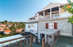 a view of a house with a balcony at 1 Bedroom Nice Apartment In Splitska in Splitska