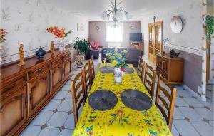 a dining room with a yellow table and chairs at Lovely Home In Quoux-Haut-Maînil in Haut-Maînil