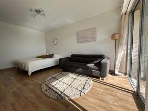 a living room with a couch and a bed at Sea view flat with car park boarder Cannes in Le Cannet +12 photos