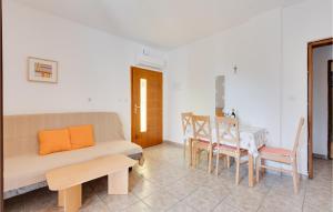 a living room with a couch and a table at Cozy Apartment In Krk With Wifi in Krk