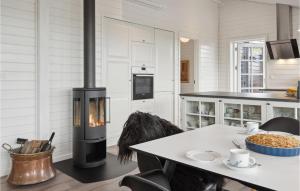 a kitchen with a stove and a table in a room at 3 Bedroom Stunning Home In Hejls in Hejls