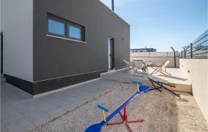 a house with three bikes parked outside of it at Beautiful Home In Pula With Kitchen in Pula