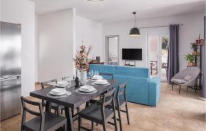 a living room with a table and a blue couch at Beautiful Home In Koromacno With Wifi in Koromačno +24 photos
