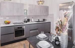 a kitchen with a table and a counter top at Beautiful Home In Koromacno With Wifi in Koromačno