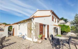 a house with a patio and a table and chairs at Beautiful Home In Saint-André in Saint-André