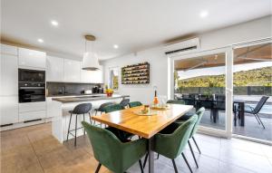 a kitchen and dining room with a table and chairs at Stunning Home In Krusevo in Kruševo