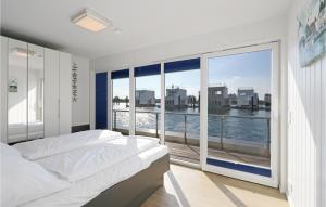 a bedroom with a bed and a large window at Captain Jack Sparrow in Olpenitz