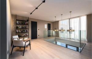 a living room with a glass table and a chair at Nice Home In Pula With Kitchen in Štinjan