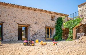 a group of toys sitting in front of a building at Awesome Home In Pardailhan With Kitchen in Pardailhan