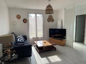 a living room with a couch and a coffee table at Ty Bihan in Crozon