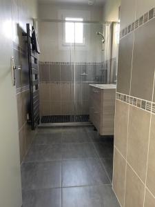 a large bathroom with a shower and a sink at Ty Bihan in Crozon +23 photos