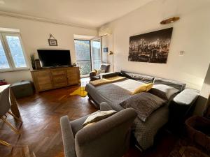 a living room with a couch and a flat screen tv at Apartment by the sea in Ika