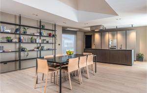 a kitchen and dining room with a table and chairs at Nice Home In Pula With Kitchen in Štinjan