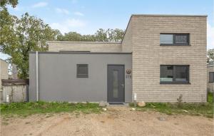 a gray house with a brick at Lovely Home In Lembruchdümmer See in Lembruch +38 photos