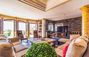 a living room with couches and a tv at 7 Bedroom Stunning Home In Frigiliana in Acebuchal