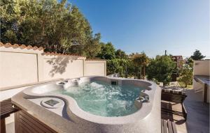 a hot tub on the side of a patio at 4 Bedroom Amazing Home In Barbat in Barbat na Rabu +39 photos