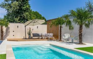 a swimming pool in a backyard with a table and an umbrella at Villa Bonaca in Medulin