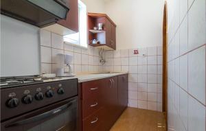 a small kitchen with a stove and a sink at Lovely Apartment In Barbat Na Rabu in Barbat na Rabu