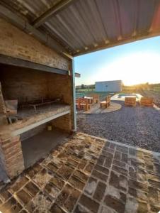 a brick building with a patio with a stone floor at El retiro, casa de campo in San Antonio de Areco +11 photos