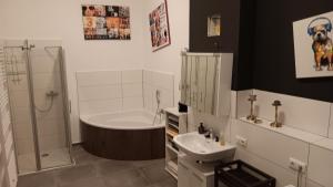 a bathroom with a sink and a shower and a toilet at Meisterhaus Apartment 2 in Glauchau +16 photos