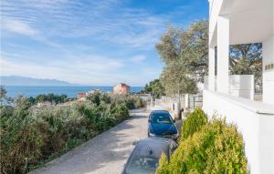 a car parked on a street next to a house at 1 Bedroom Awesome Apartment In Podaca in Podaca