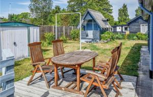 a wooden table and four chairs on a patio at Two-Bedroom Holiday Home In Hornslet in Hornslet