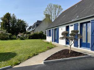 a tree in a pot in front of a building at Ty Bihan in Crozon