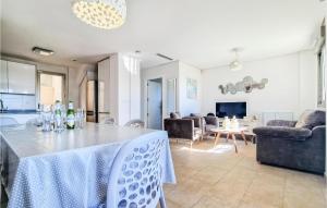 a kitchen and living room with a table and chairs at 3 Bedroom Nice Home In Torrevieja in Torrevieja